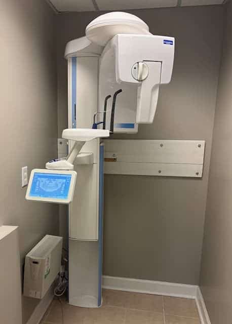 A dental office with a large machine in the corner.